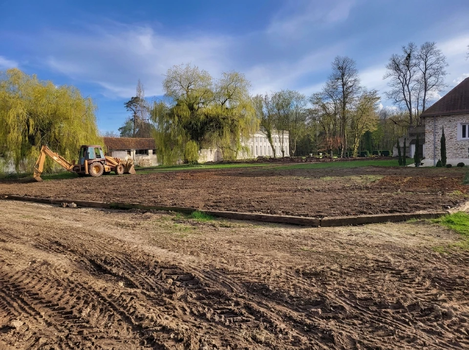 Chantier extérieur d'installation de piscine hors-sol ovale en cours de montage dans jardin résidentiel